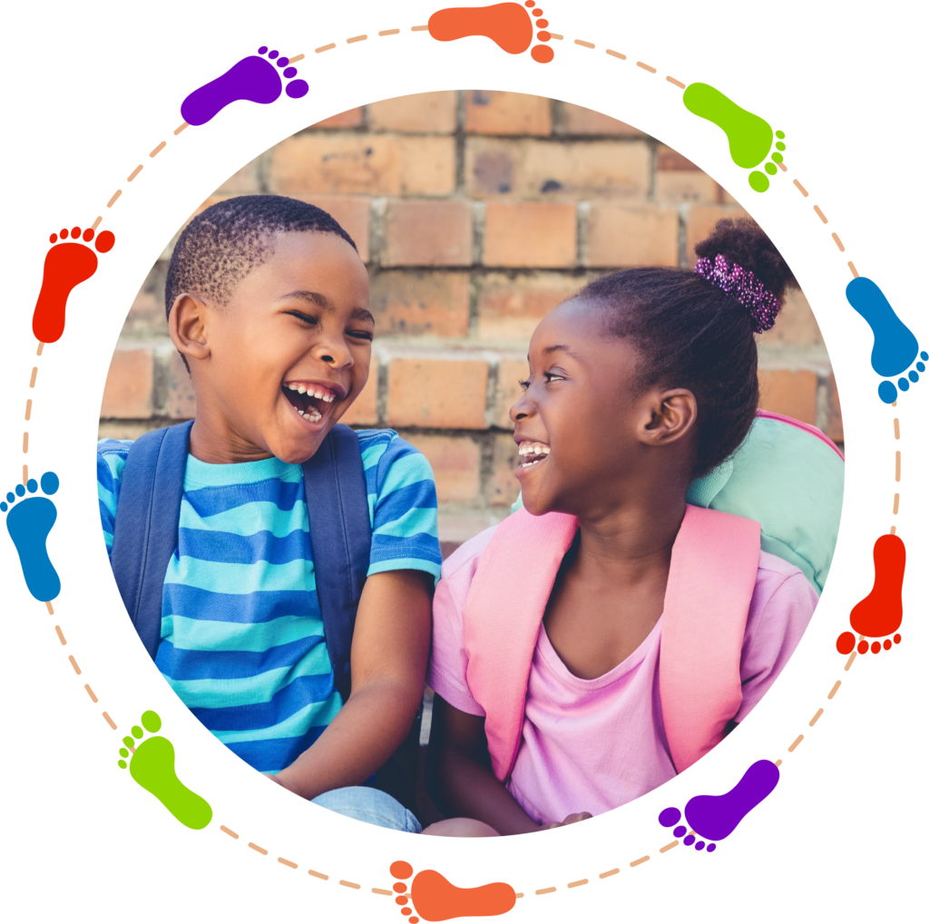 Two children are laughing together in a circle.